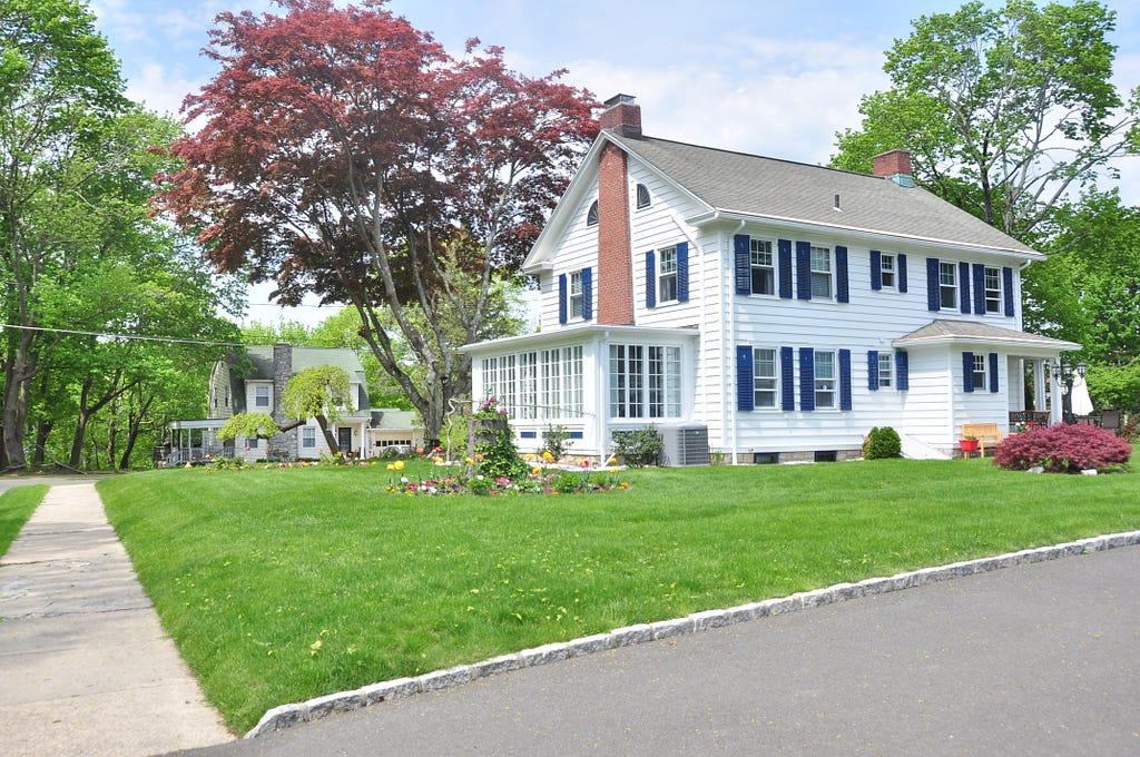 green lawn grass with white house