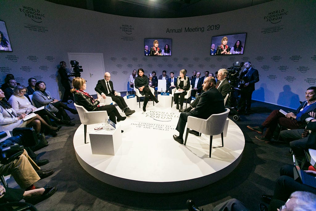 A panel discussion from the World Economic Forum in 2019 featuring experts discussing a topic in front of an audience