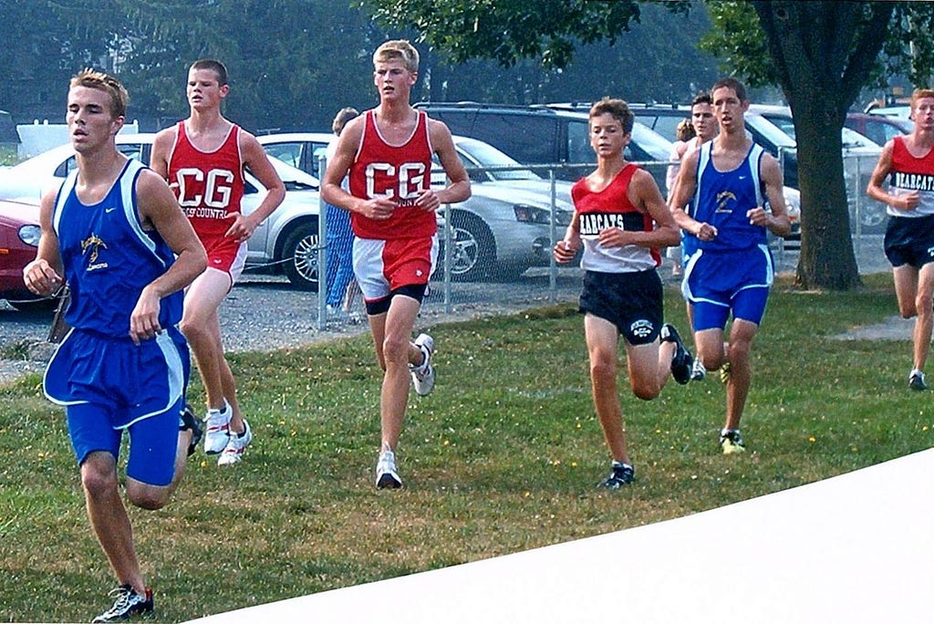 Luke Brenneman photographed running amongst several competitors and his own team mates. He is clearly much smaller in size.