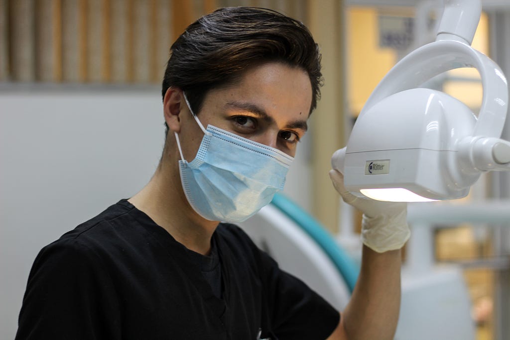 A dentist preparing to examine your teeth and dating life