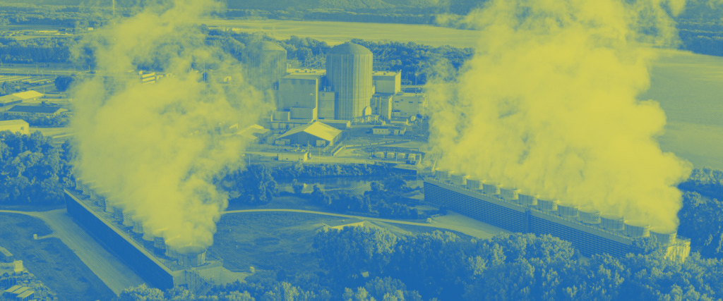 Clouds of steam rise from a direct air capture facility surrounded by trees.