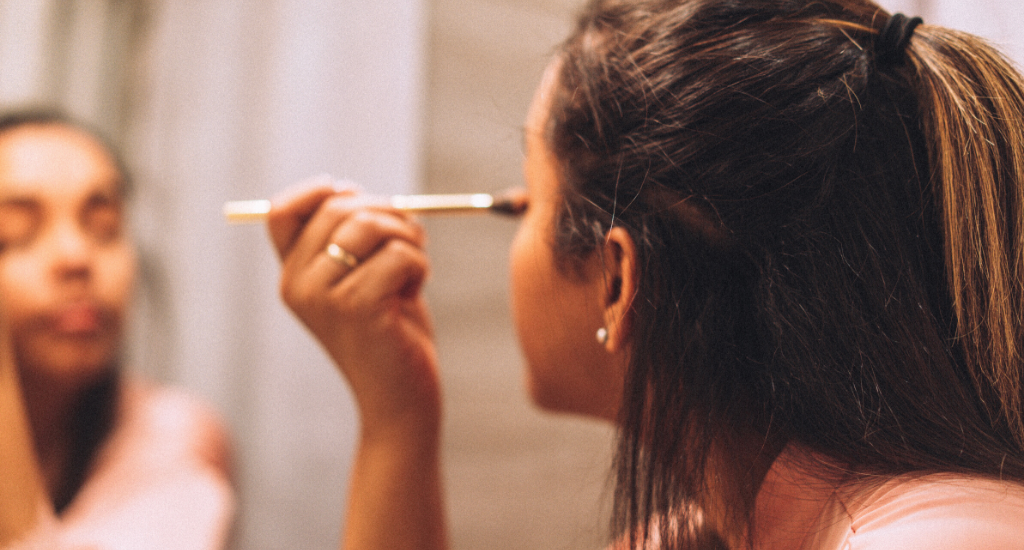 Woman applying eyeshadow.