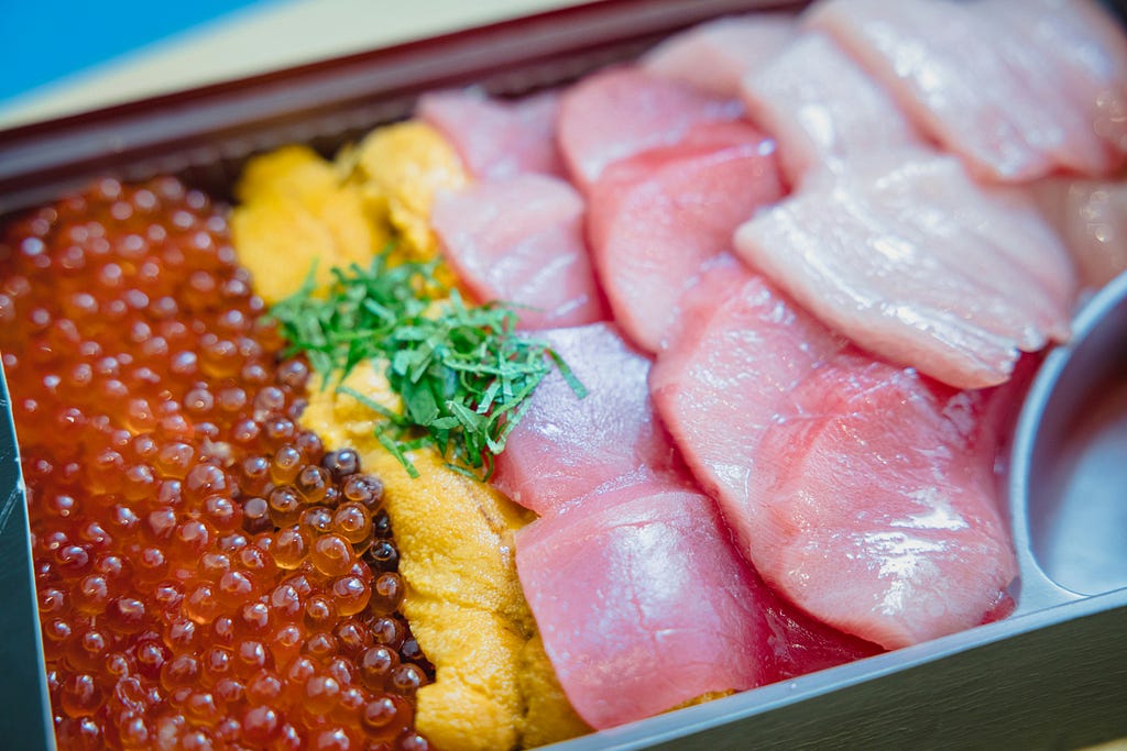 A dietary source of Omega-3 fatty acid; a raw fish placed in a small plastic container.