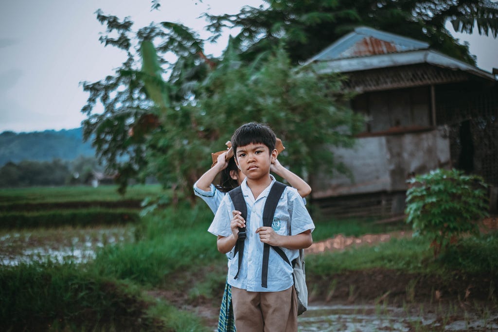 a Filipino kid struggling to go to school because of the location they live in and their substandard living conditions