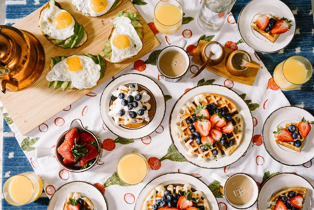 A big breakfast table with various foods