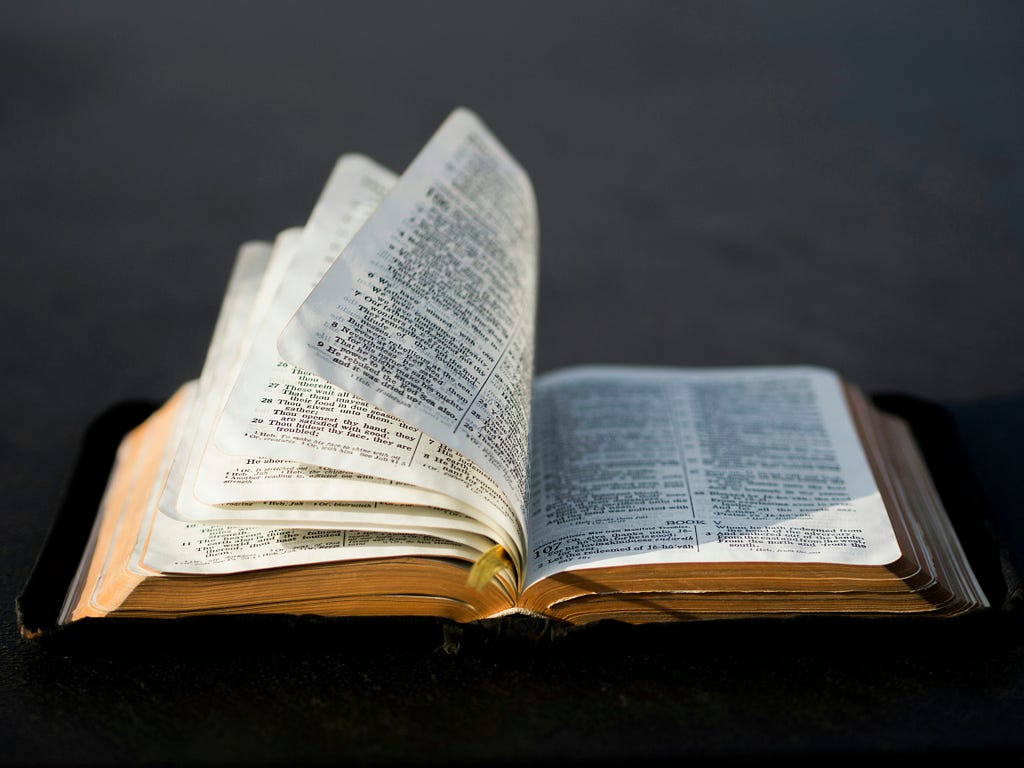 An open Bible with pages turning.