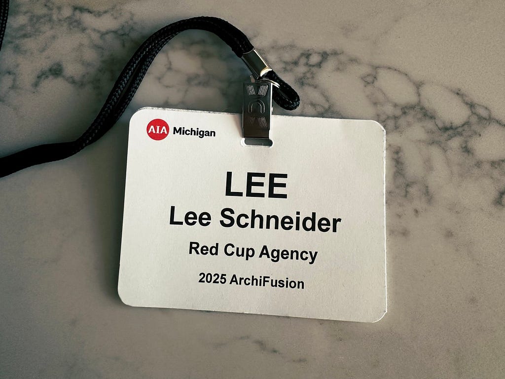 Lee Schneider’s ID badge from AIA Archifusion. White badge, black lettering with his name.