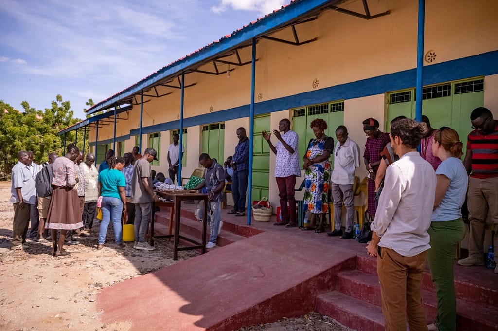 Turkana community leaders and members of the study team gathering to share a meal and discuss the ongoing research project during the Turkana Cultural Festival.