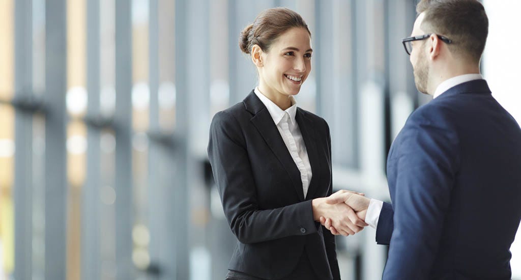 CEO giving handshake to new employee