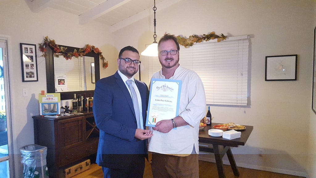 Sahag Yedalian representing Paul Krekorian's office (left) presents a certificate of appreciation from the City of Los Angeles to Executive Director Todd Bol on behalf of the Little Free Library organization.