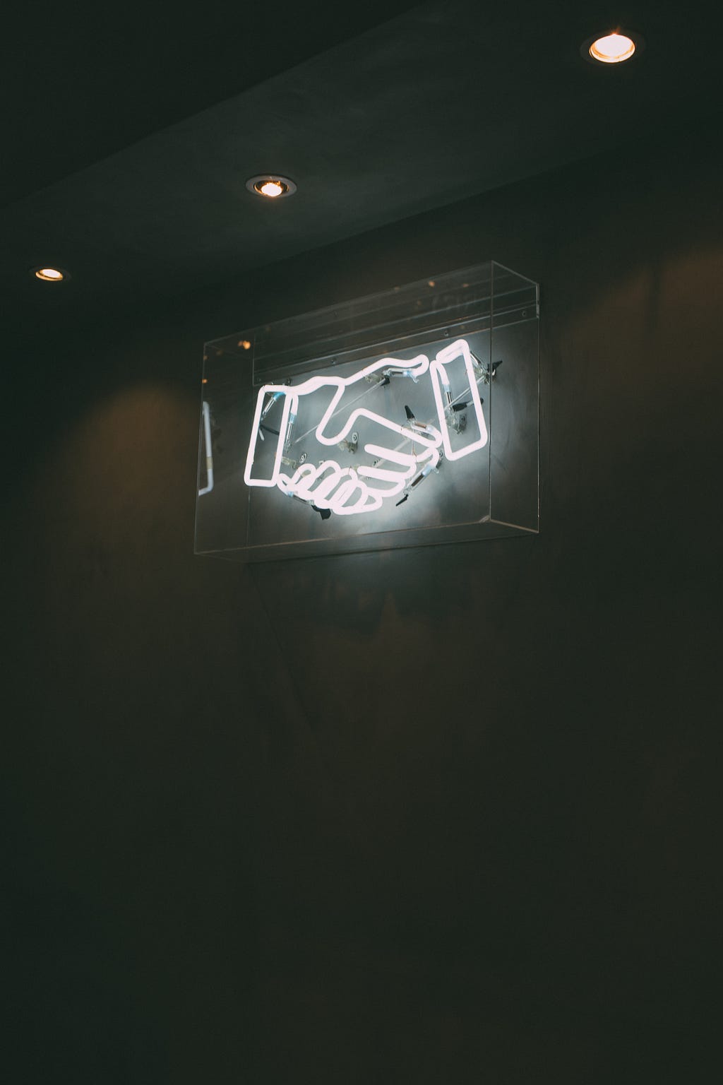 Neon sign of a handshake