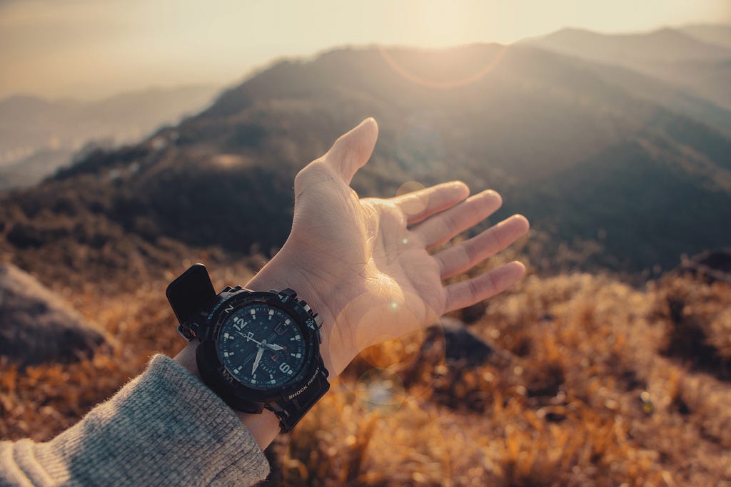 A picture of a person in the mountains wearing a sports watch