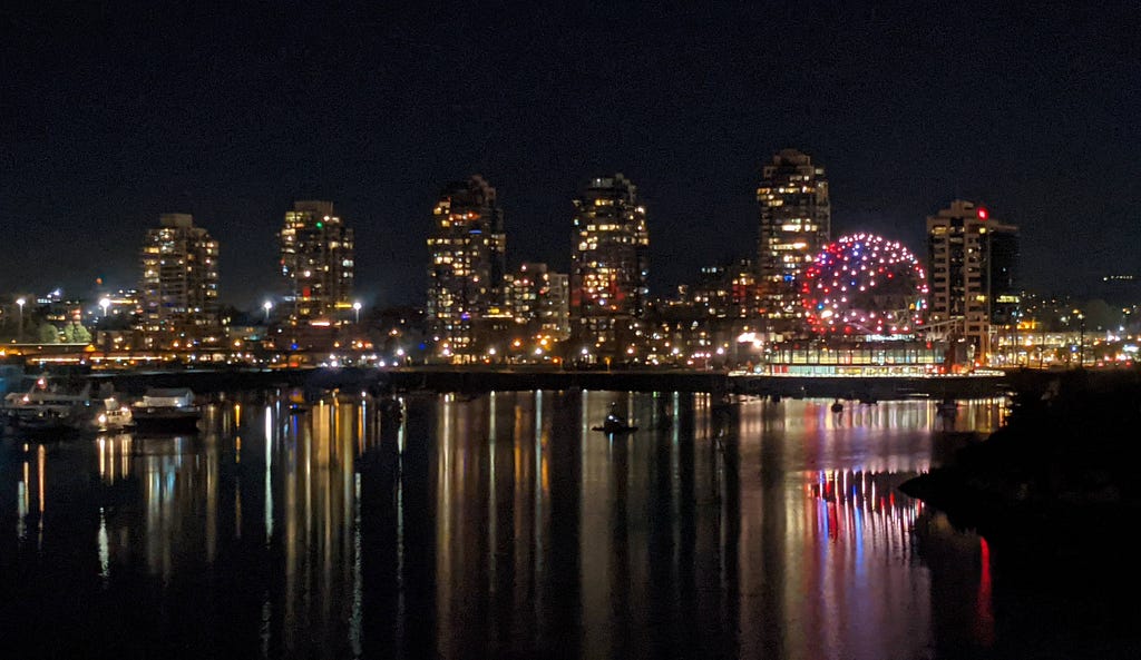 City view across the water in Vancouver with the lights reflected in the water