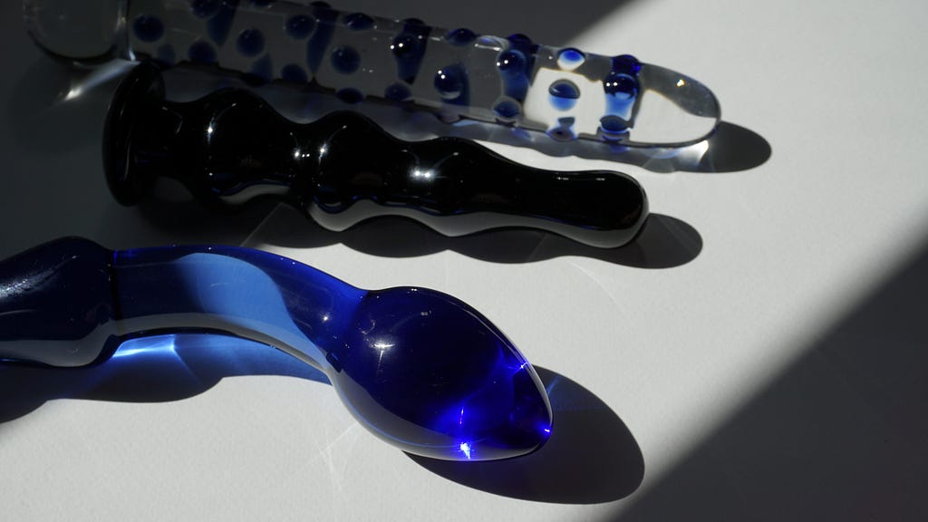 Photo of three glass sex toys in blue