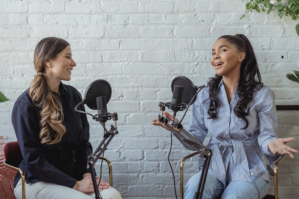 Two Beautiful girls talking in a podcast.