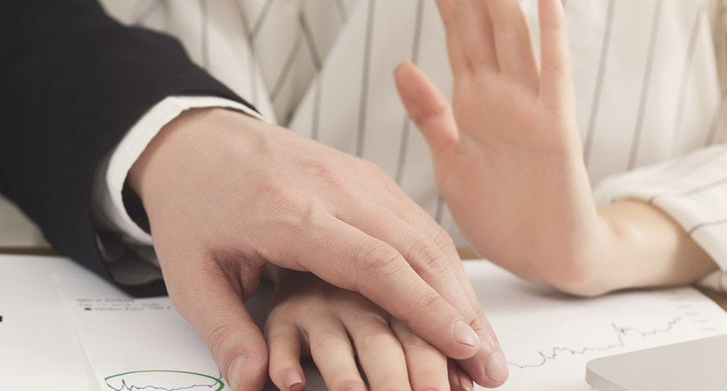 Man touching his female colleague's hand