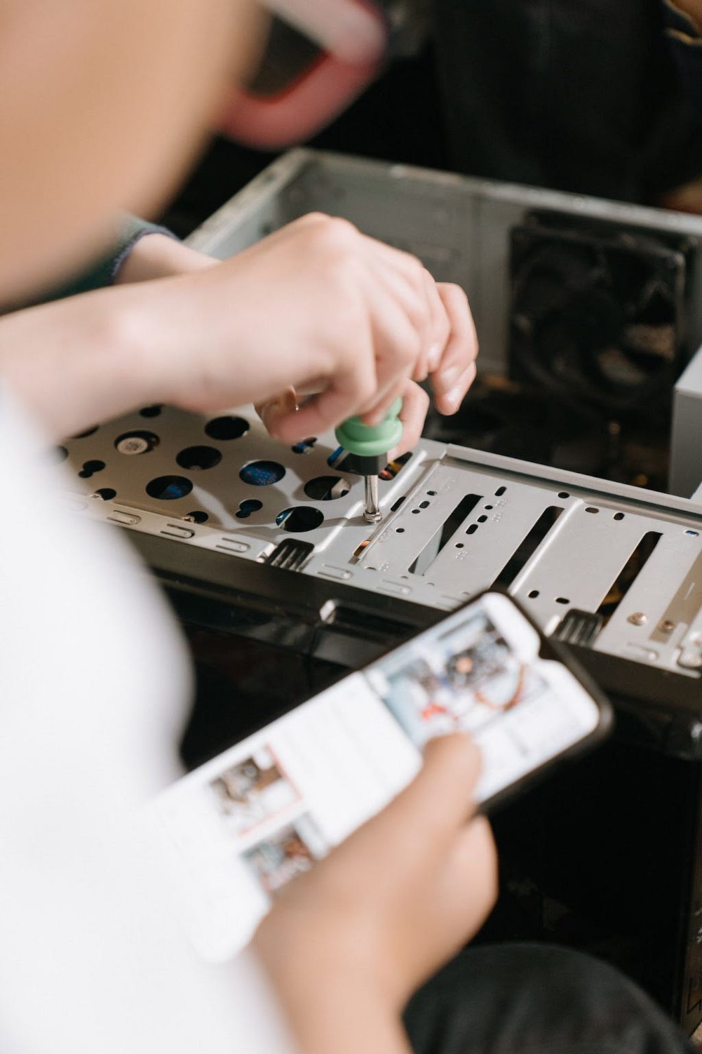 A person repairing a desktop computer