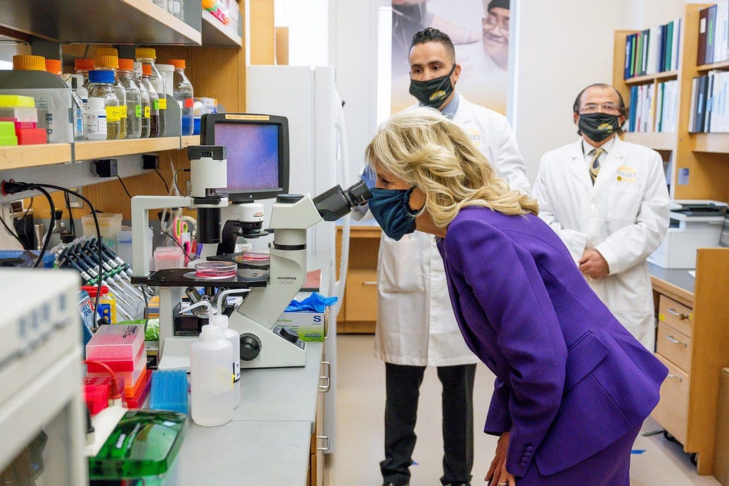 First Lady Jill Biden looks through a microscope on Feb. 24, 2021, during her tour of the McGlothlin Medical Education Center.