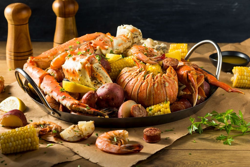 Platter of Seafood Boil sitting on brown paper.