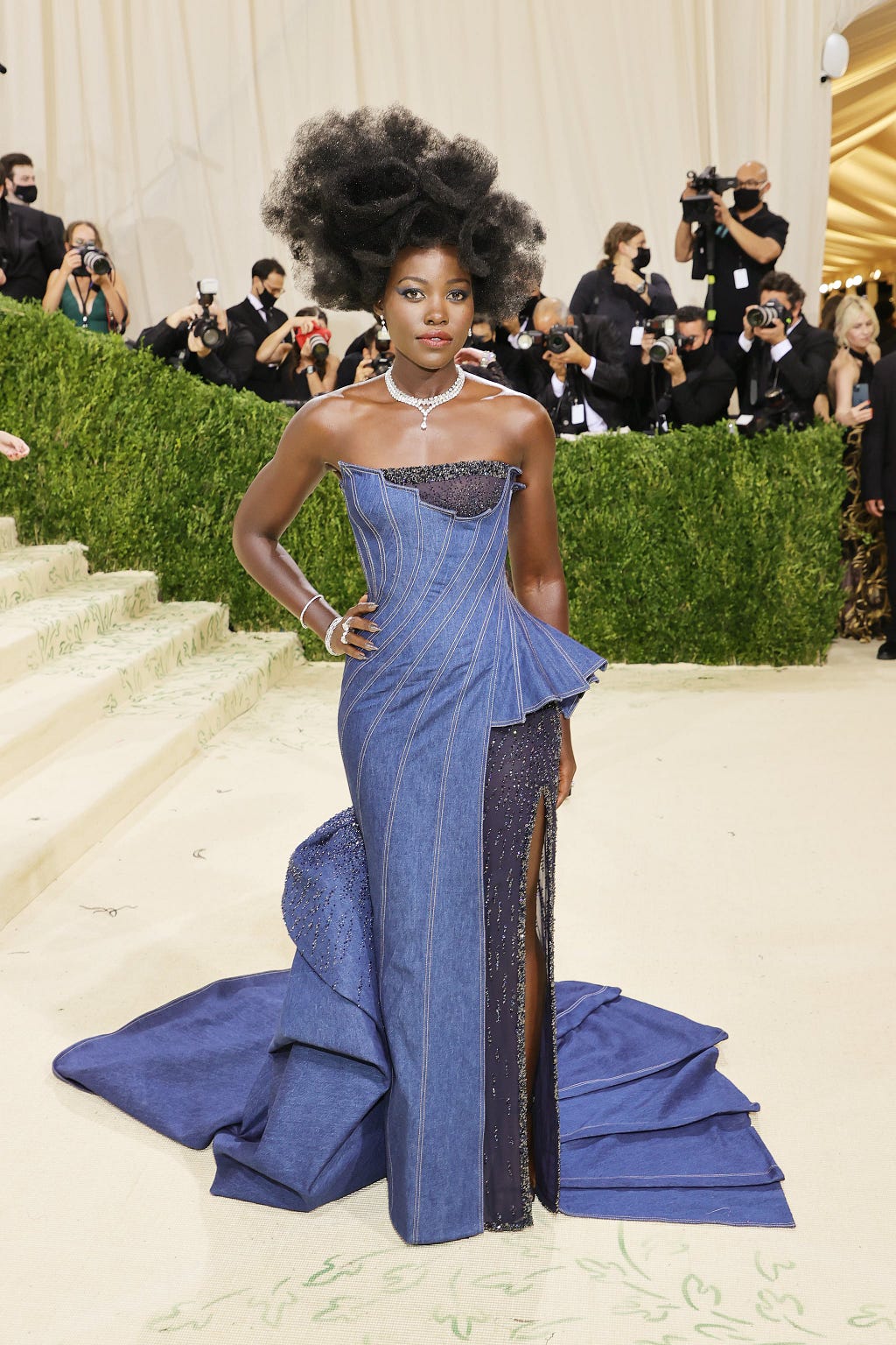 Lupita Nyong’o in a denim dress at the entrance of the Met.