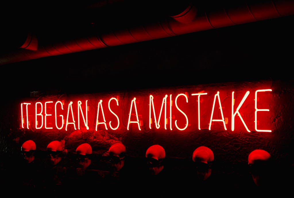 A red lighten text that says: It began as a mistake.