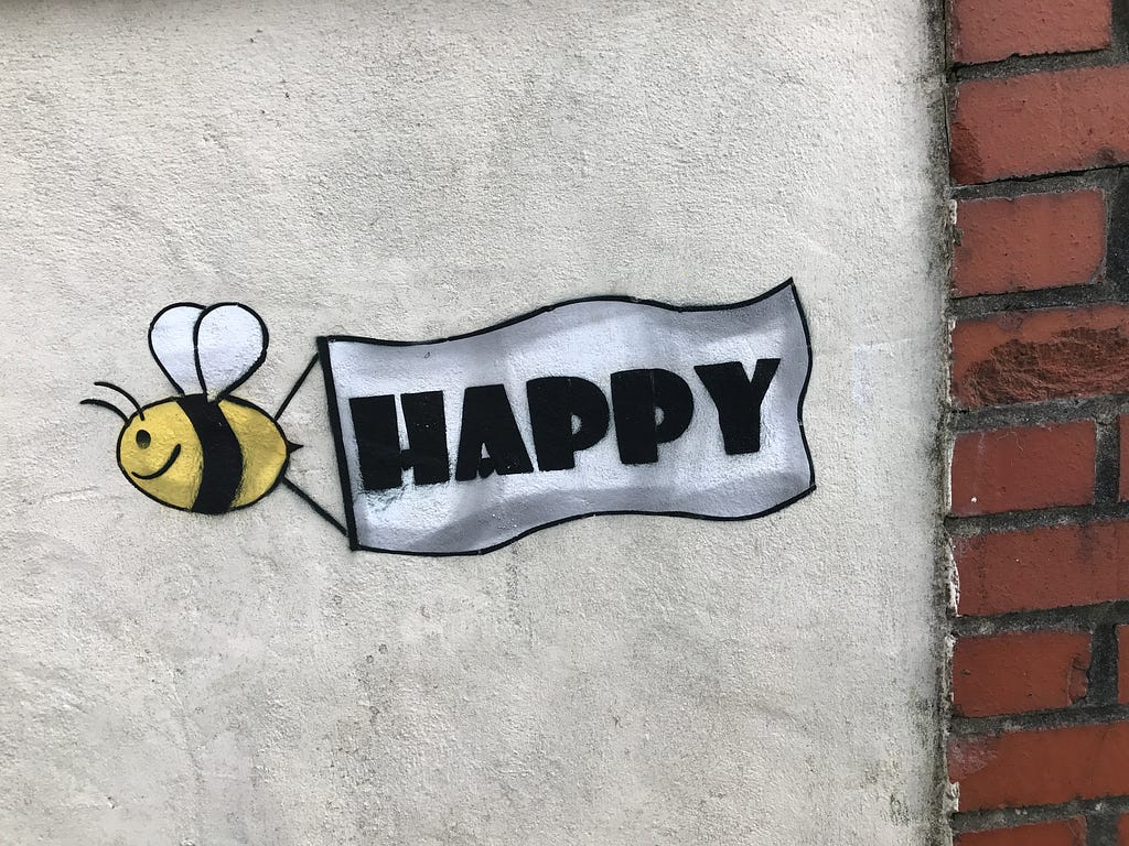 picture of bee flying with  banner that says happy — bee +happy