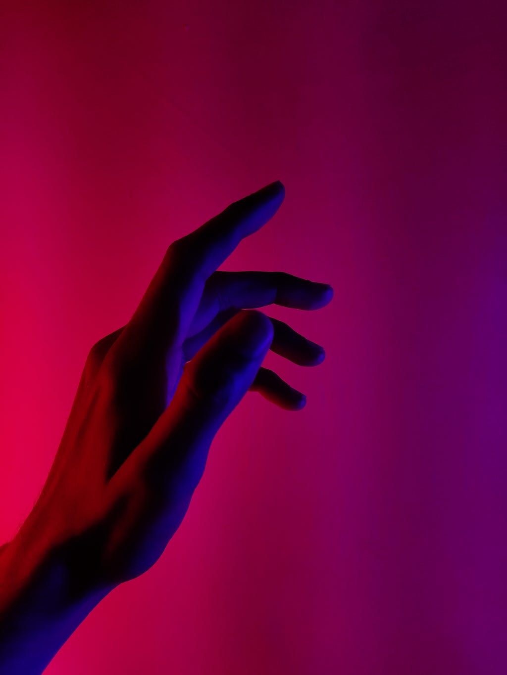 A woman’s palm against a pink background.