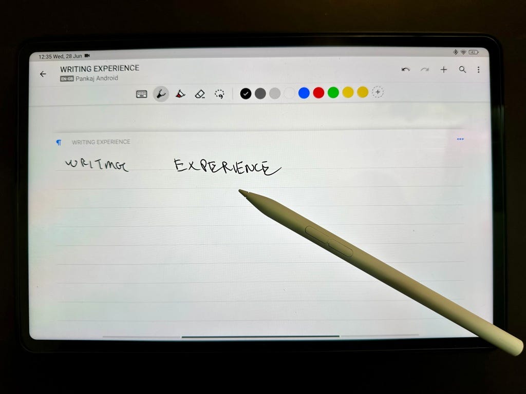 Smart Pen 2 laying over Pad 6 Display with Nebo app open with text Handwriting Experience