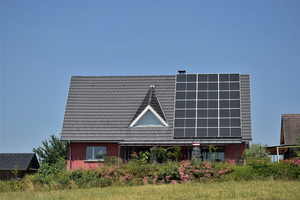 A home equipped with solar panels on its roof making home more energy efficient