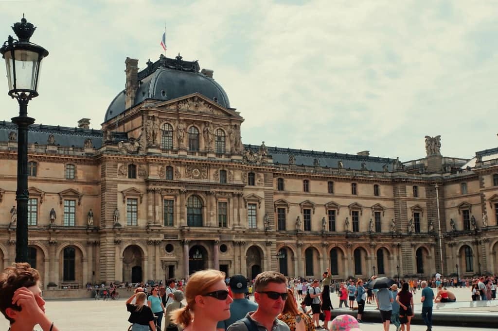 A group of people standing in front of an ornate building.