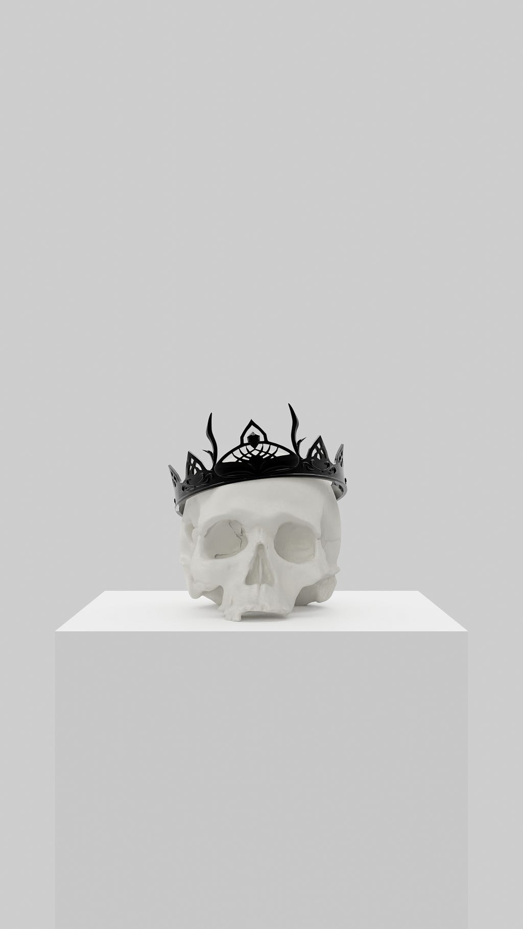 A skull resting on a white pedestal wearing a black crown against a white background
