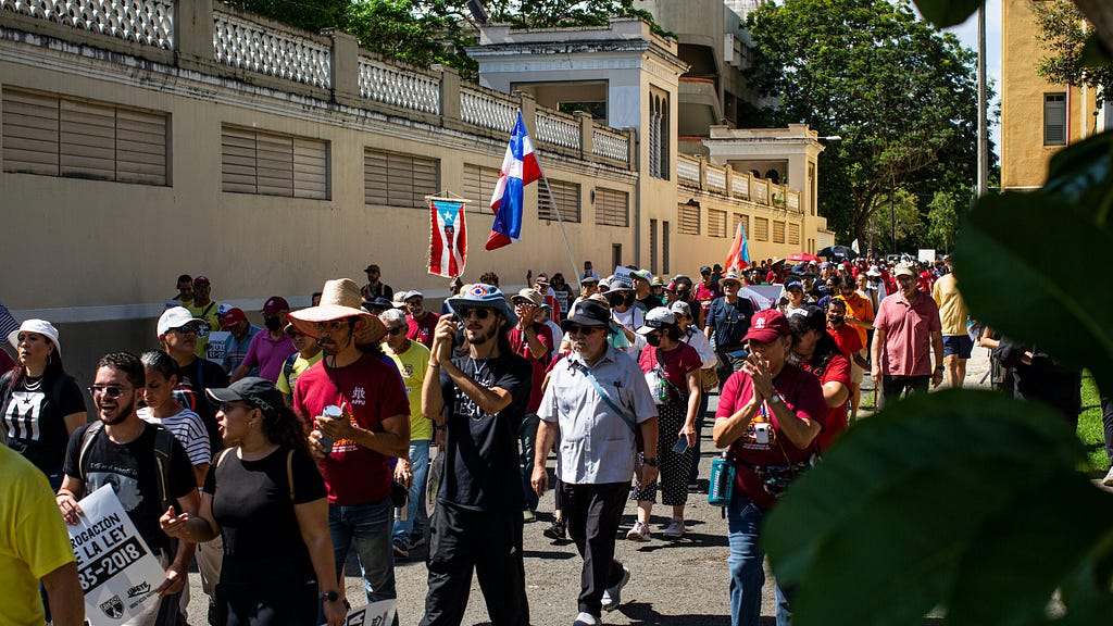 People march with Puerto Rican flags