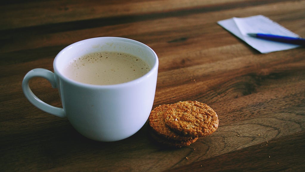 A cup of tea and cookies on a table