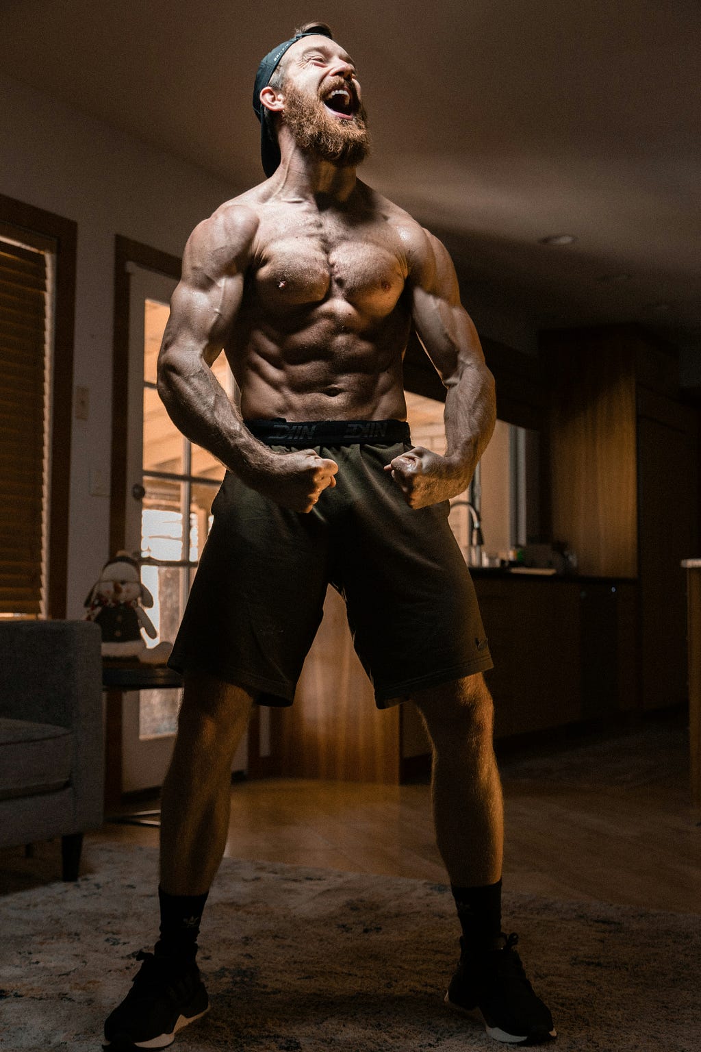 A muscular topless man flexing