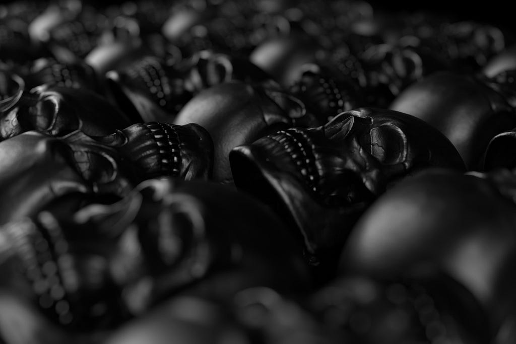 A frame filled with rows of metal skulls