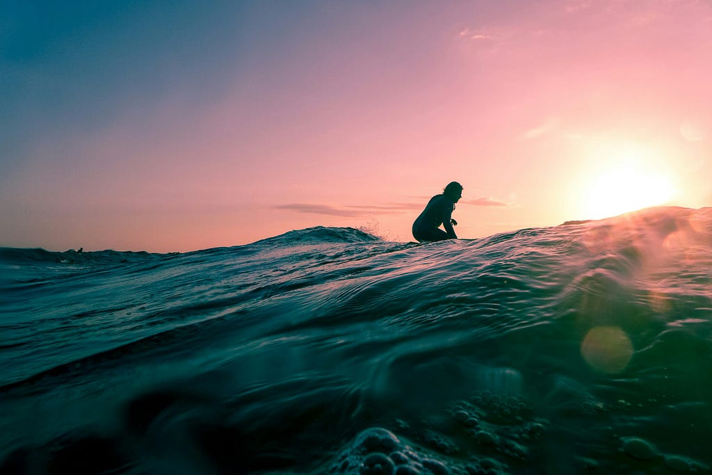 Surfing is a magical beach activity to connect with nature