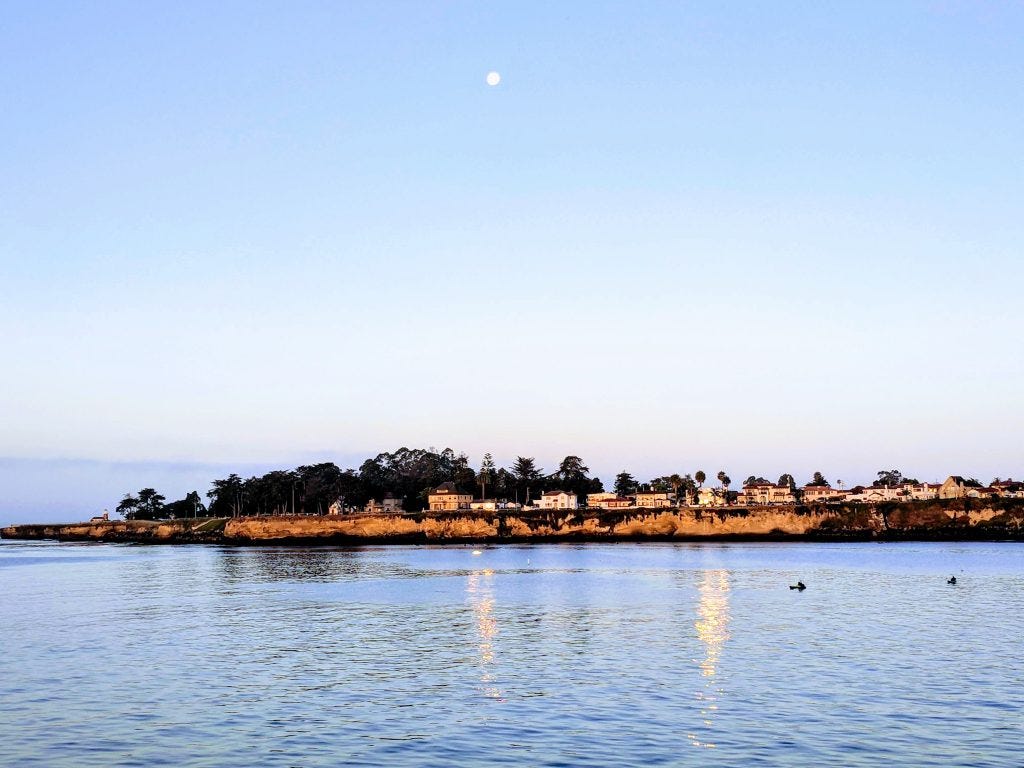 View of the point to the west of the Santa Cruz municipal wharf, with a full moon in the sky
