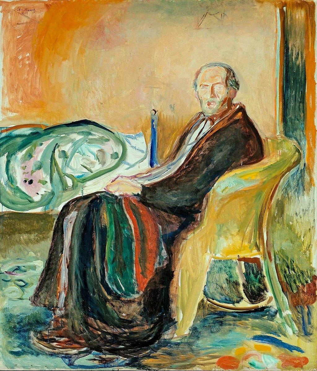 A man sits in a chair looking at the viewer