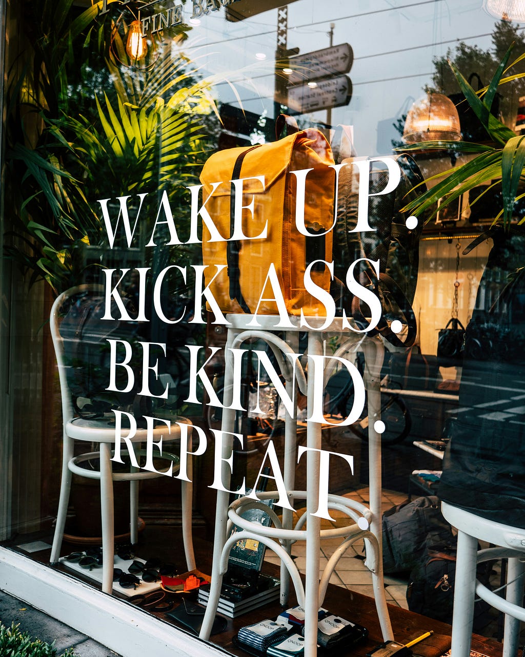 It’s a shop window filled with items to purchase. Written on the window is Wake up. Kick Ass. Be Kind. Repeat.