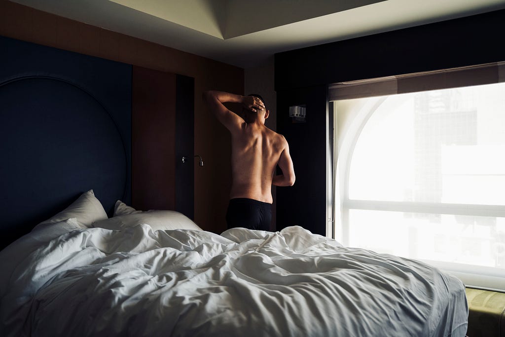 Guy getting out of bed