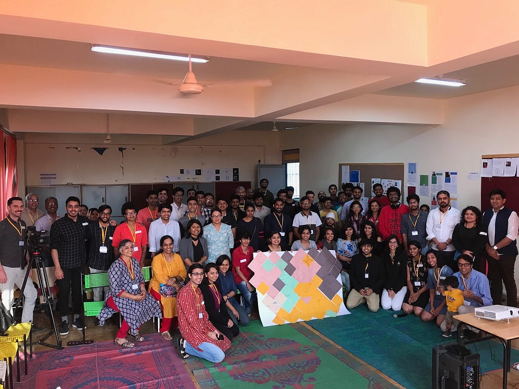 A group picture of the participants of PCD Bangalore — group of people in the center are holding the “Data Selfie” installati