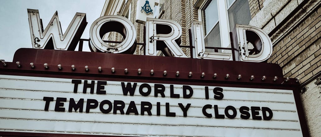 image of movie theater marquee that states the world is temporarily closed