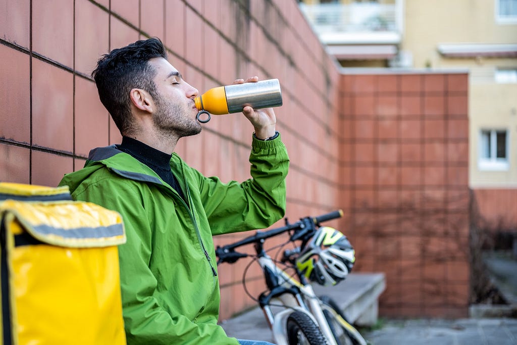 boy drinking water from smart water bottle