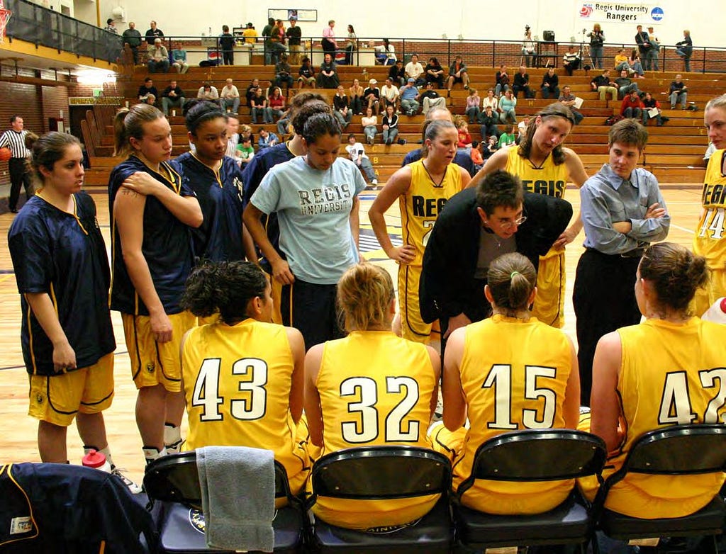 the Ranger’s basketball team huddles on the sidelines during a game in the Fieldhouse on the Northwest Denver campus