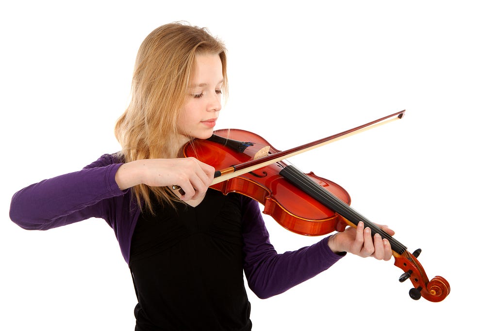 A girl playing the violin over white background .