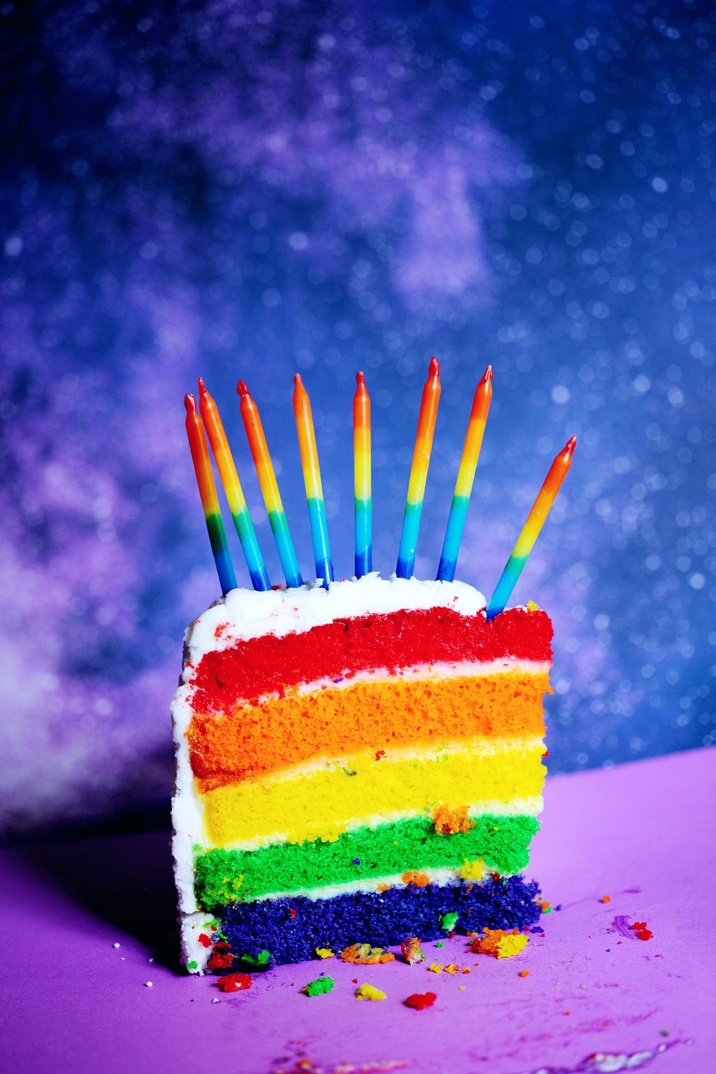 LGBTQIA+ colors birthday cake with candles
