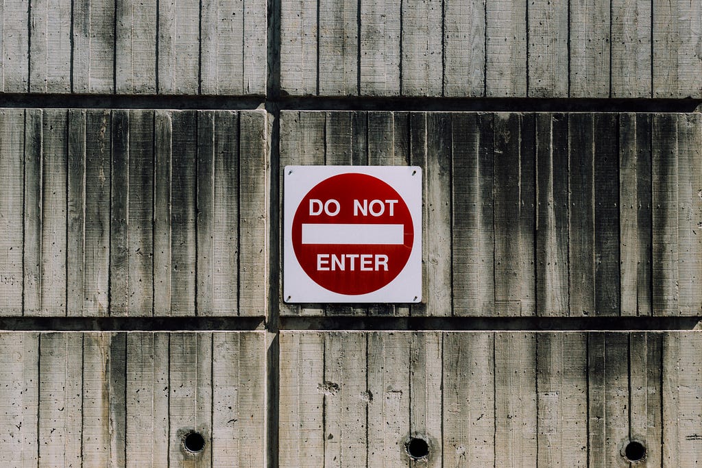 A “Do not enter” sign hangs on a wall