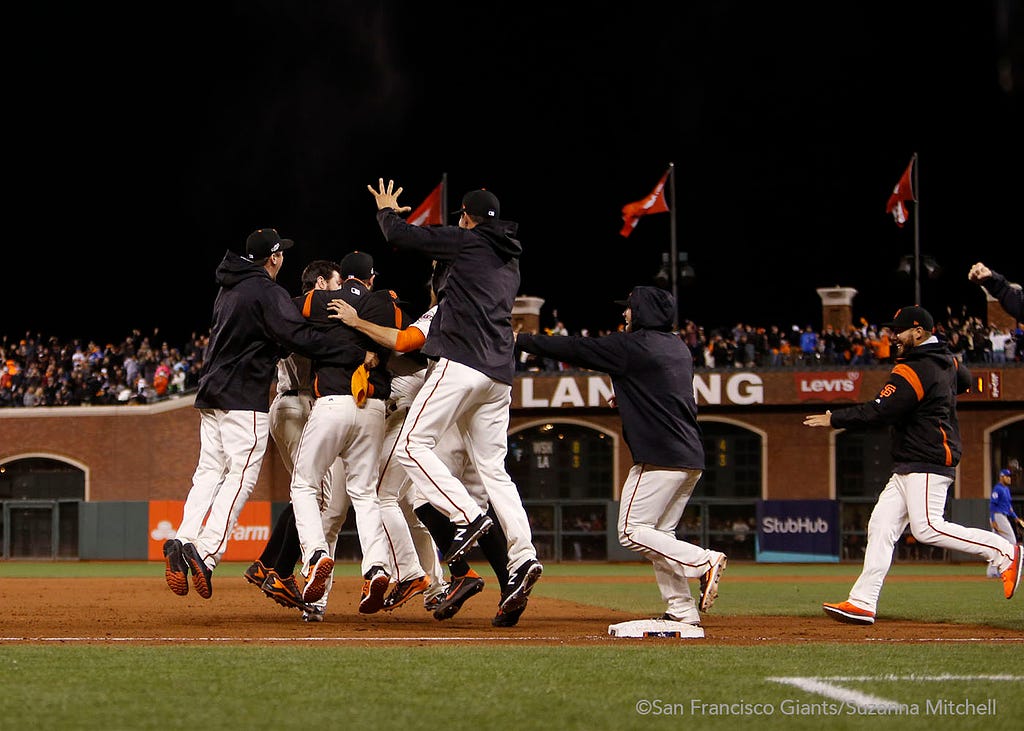 The team celebrates after Joe Panik doubled in the thirteenth inning to win the game.
