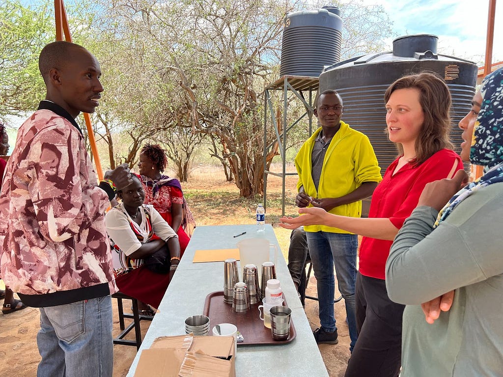 Molly Blank, biomedical engineer at Variant Bio (second from right), soliciting feedback on part of a proposed protocol during a community engagement event in Kenya.