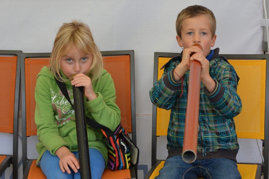 Children with their DIY didgeridoo